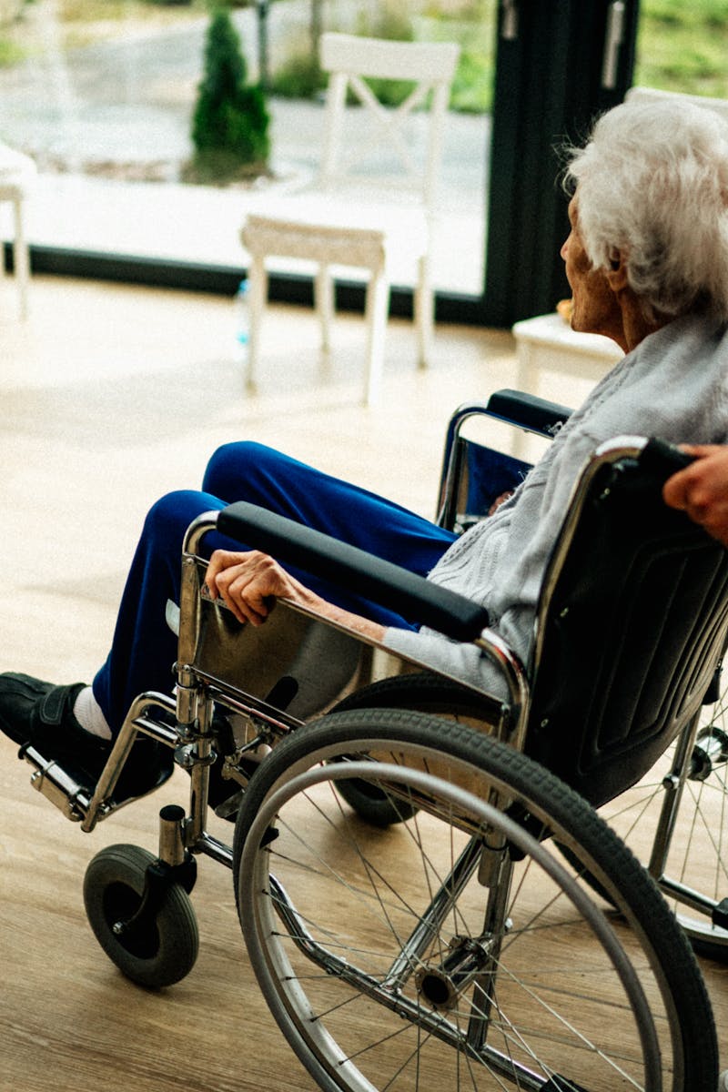 A caregiver assists a senior adult in a wheelchair at a nursing home in Prague, Czech Republic.